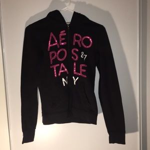 A black jacket with pink lettering .